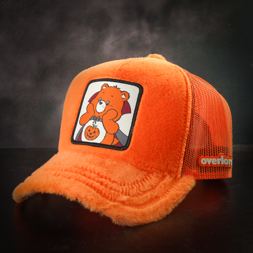 Plush orange trucker cap hat featuring Trick or Sweet Bear from Care Bears on woven patch attached to crown