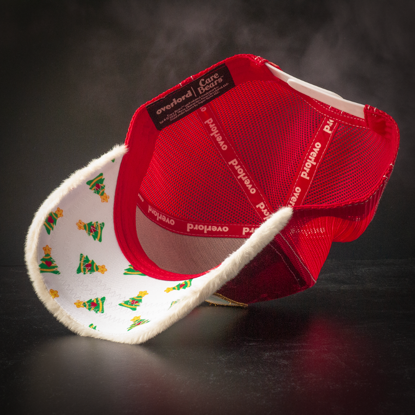 Inside view of red crushed velvet trucker cap with Christmas trees printed on white underbrim.