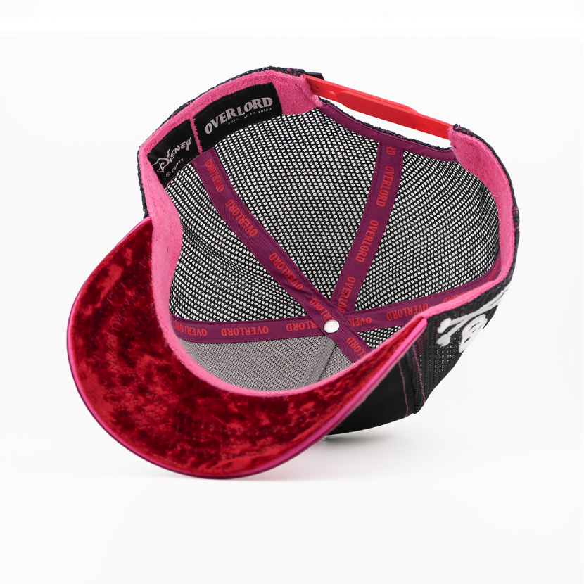 Underside of the Captain Hook retro trucker cap, showing a weathered-texture dark red brim, a Disney tag, gray mesh crown, and pink Overlord branded taping with red text.