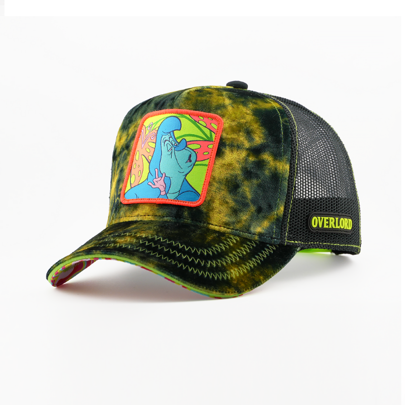 Green and black tie-dye-textured retro trucker cap with the Caterpillar from Disney's Alice in Wonderland patch on a colorful mushroom-print background, red patch border, black mesh sides, and a neon-green Overlord logo.