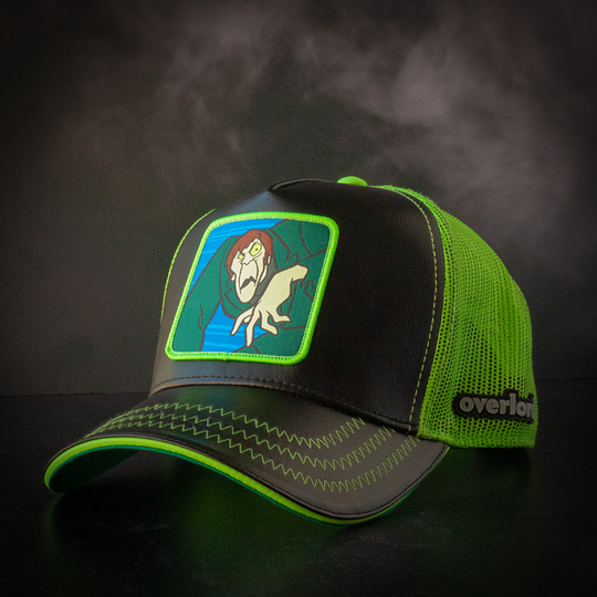 Black faux leather trucker cap with green mesh featuring a woven patch of the Creeper villain from Scooby Doo attached to the crown.
