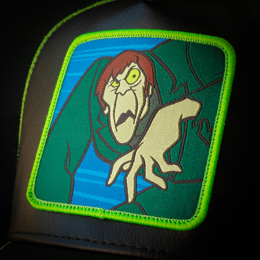 Clsoe-up of a woven patch of the Creeper villain from Scooby Doo attached to the crown.