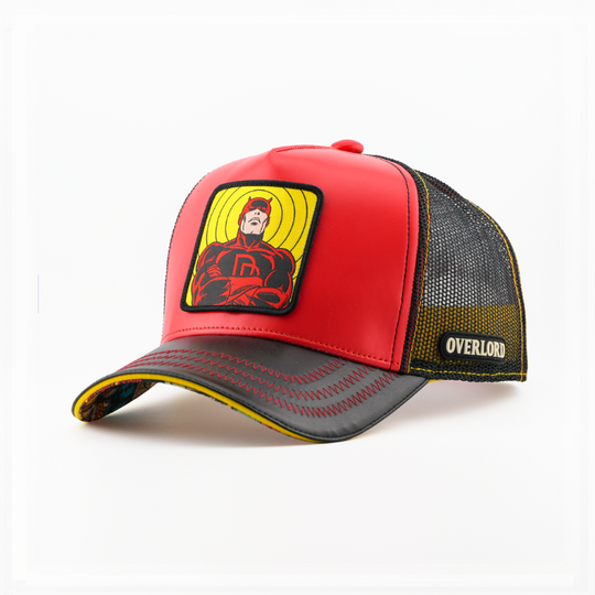 Red trucker cap with a Marvel's Daredevil patch on a yellow backdrop, a black brim, and a mesh side with the Overlord logo.