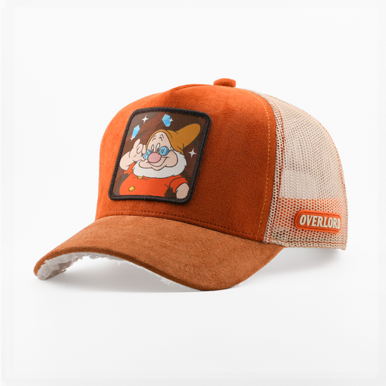 Orange suede-textured Doc from Disney's Snow White and the Seven Dwarfs retro trucker cap with a brown brim, tan mesh side, and Overlord logo.