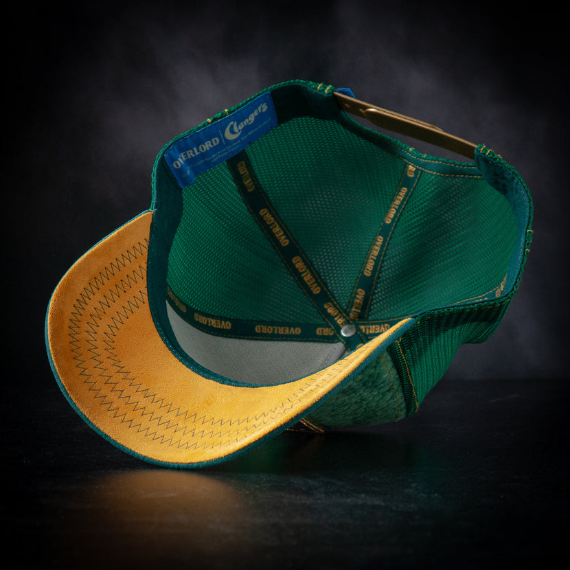 Green and yellow cap with brand logo on a dark background