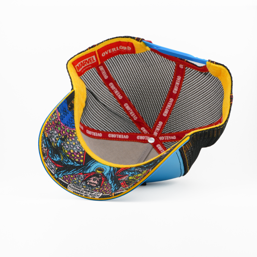 Underside view of the Doctor Strange cap showing a comic-print brim, black mesh crown, and red Overlord branded taping.