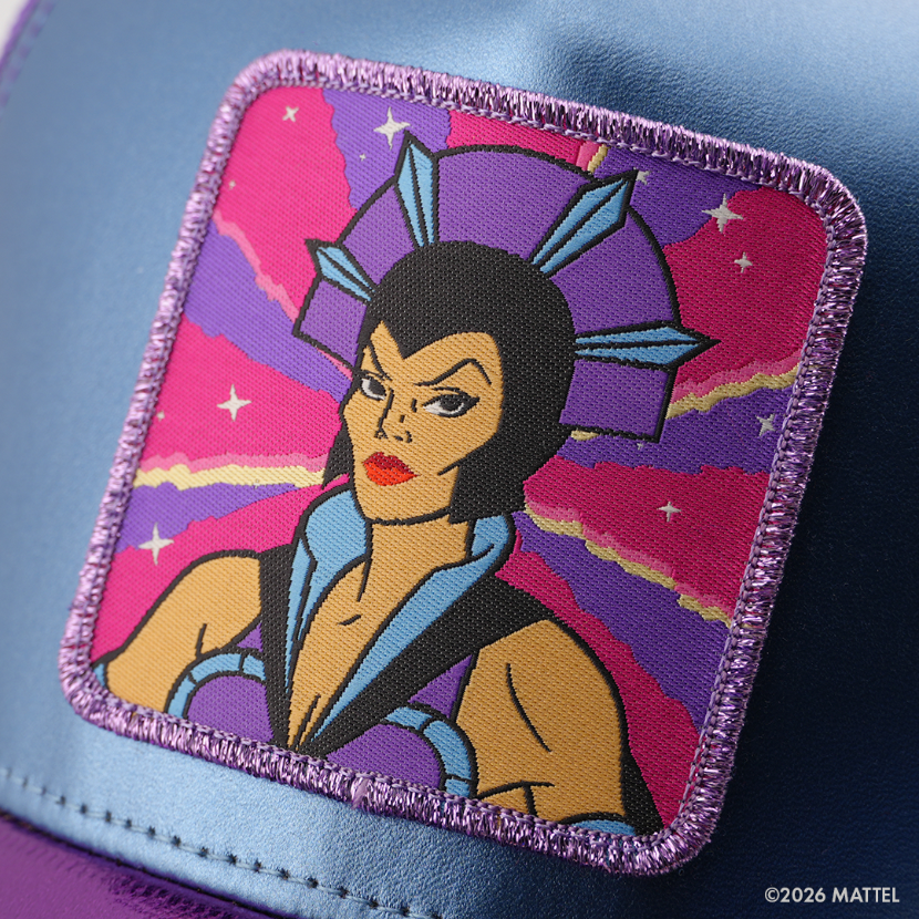 Woven patch of Evil-Lynn from Masters of the Universe with a blue jeweled headdress and black hair, set against a pink and purple starry background with purple border, stitched onto the metallic blue retro trucker cap.