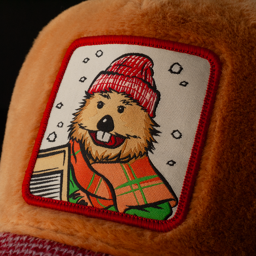 Close-up of a woven patch of Harvey the Beaver from Emmet Otter attached to the crown.