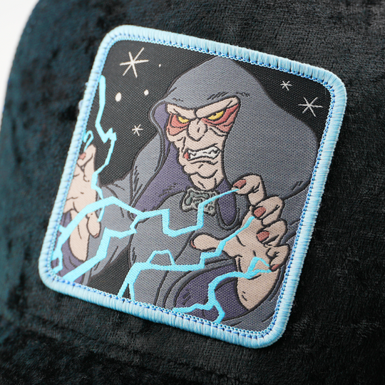 Close-up of the Emperor Palpatine from Star Wars patch shooting lightning from his hands, stitched onto the black velvet trucker cap fabric.