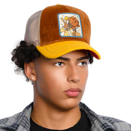 Model wearing the brown Charlie Muskrat from Emmet Otter retro trucker cap with cream mesh sides.