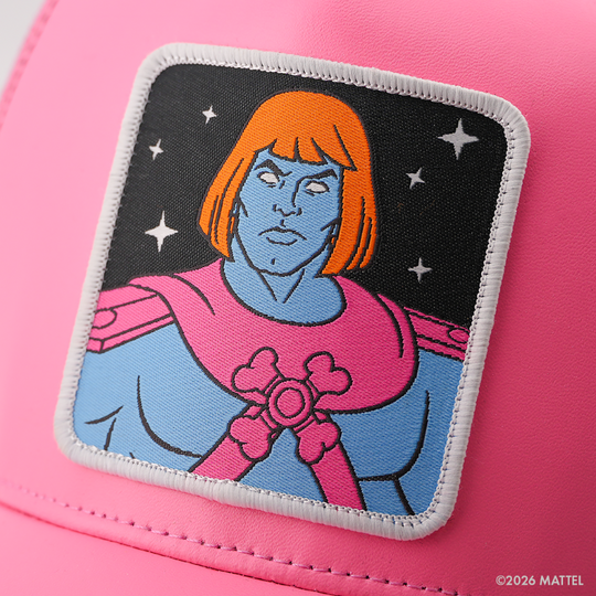 Woven patch of Faker from Masters of the Universe with blue skin and orange hair, wearing pink and blue armor against a black starry background with white border, stitched onto the pink faux-leather retro trucker cap.