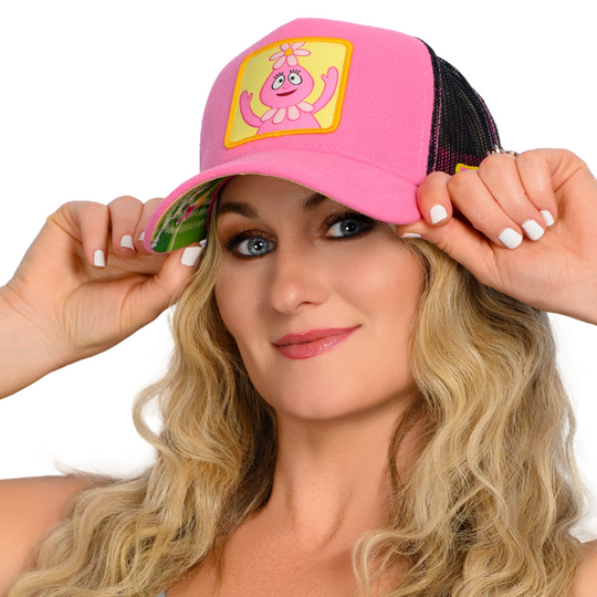 Woman wearing pink fleece trucker cap hat featuring Foofa from Yo Gabba Gabba on woven patch attached to crown