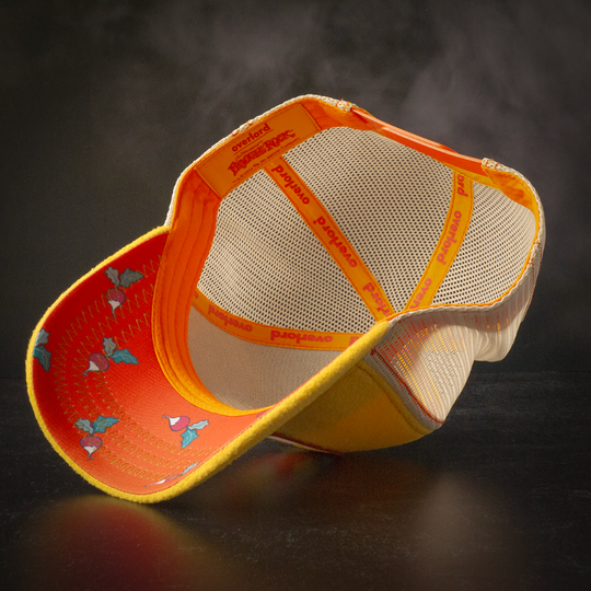 Inside view of yellow fleece trucker cap hat with Fraggle Rock beets printed fabric underbrim