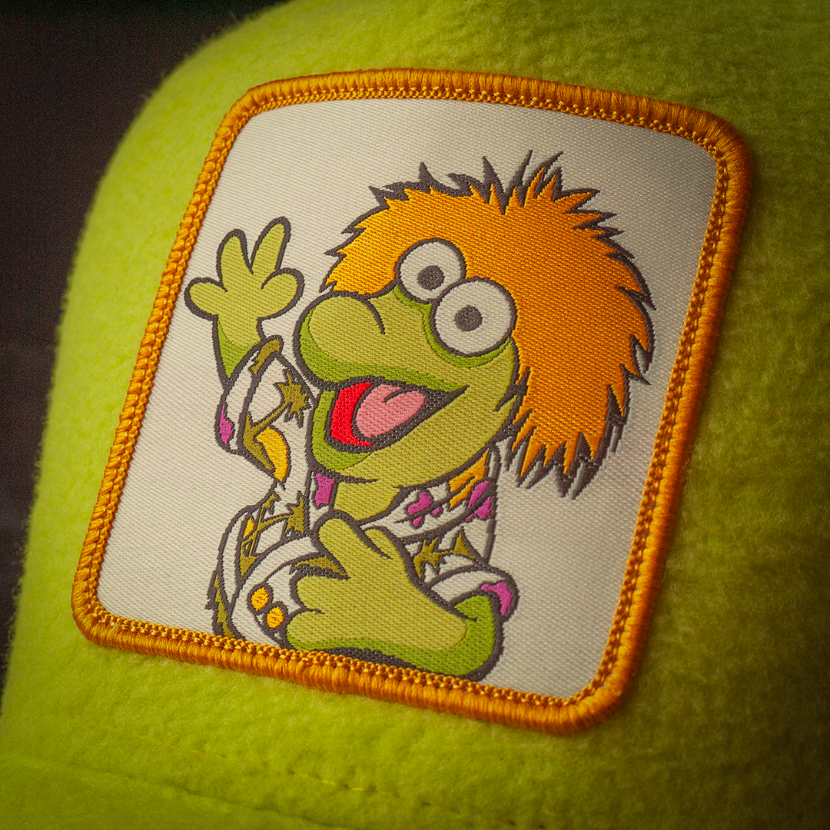 Close-up of Fraggle Rock Wembley woven patch on yellow fleece trucker cap hat 