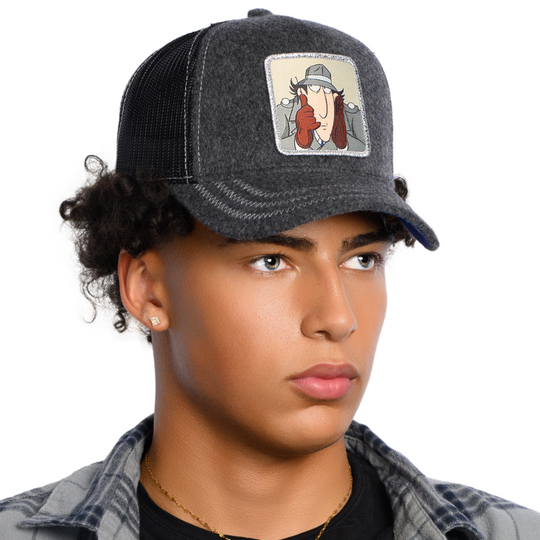 Man wearing dark gray cashmere wool trucker cap hat with Inspector Gadget woven patch against a white background