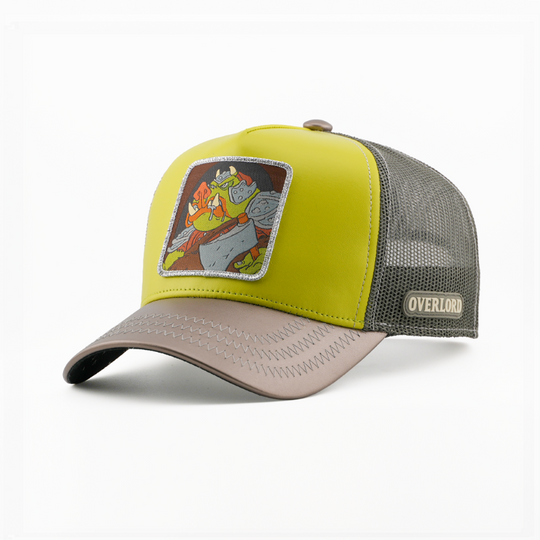 Olive green trucker cap with a Gamorrean Guard from Star Wars patch, taupe brim, gray mesh sides, and Overlord side logo.