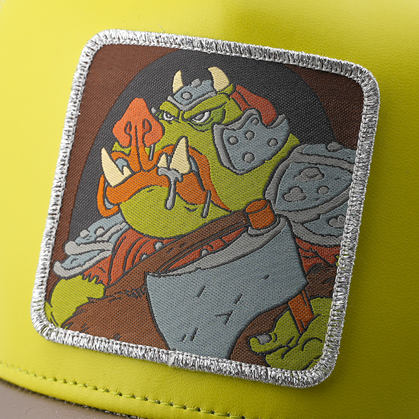 Close-up of the Gamorrean Guard from Star Wars patch with metallic silver border, stitched onto the olive green trucker cap fabric.