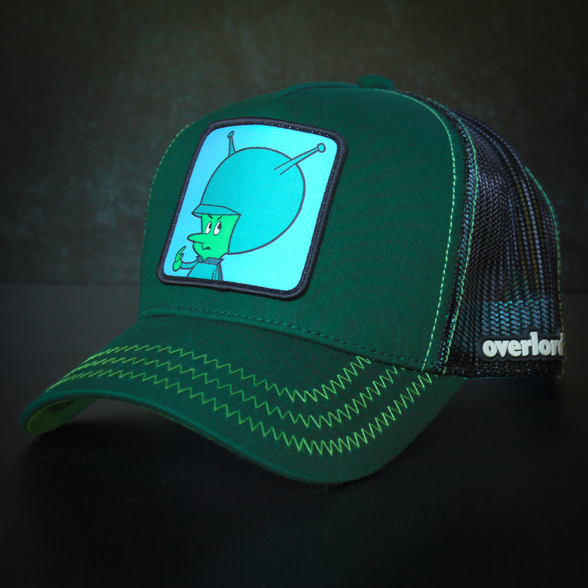 Forest green OVERLORD X Flintstones Great Gazoo trucker baseball cap hat with green zig zag stitching. PVC Overlord logo.