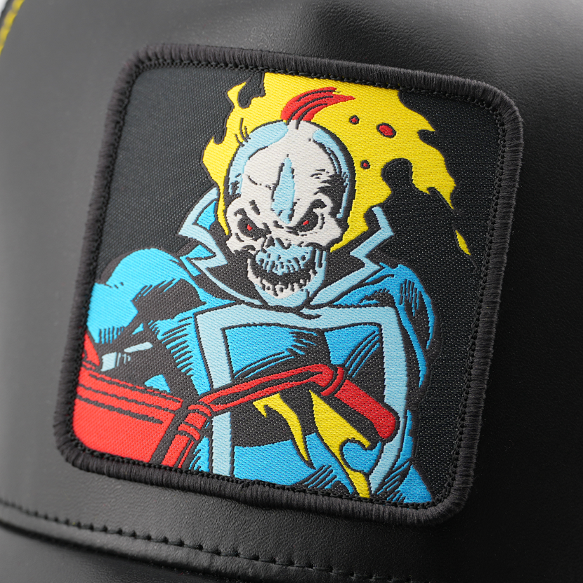 Close-up of a woven Marvel's Ghost Rider patch with a black border, stitched onto glossy black cap fabric.