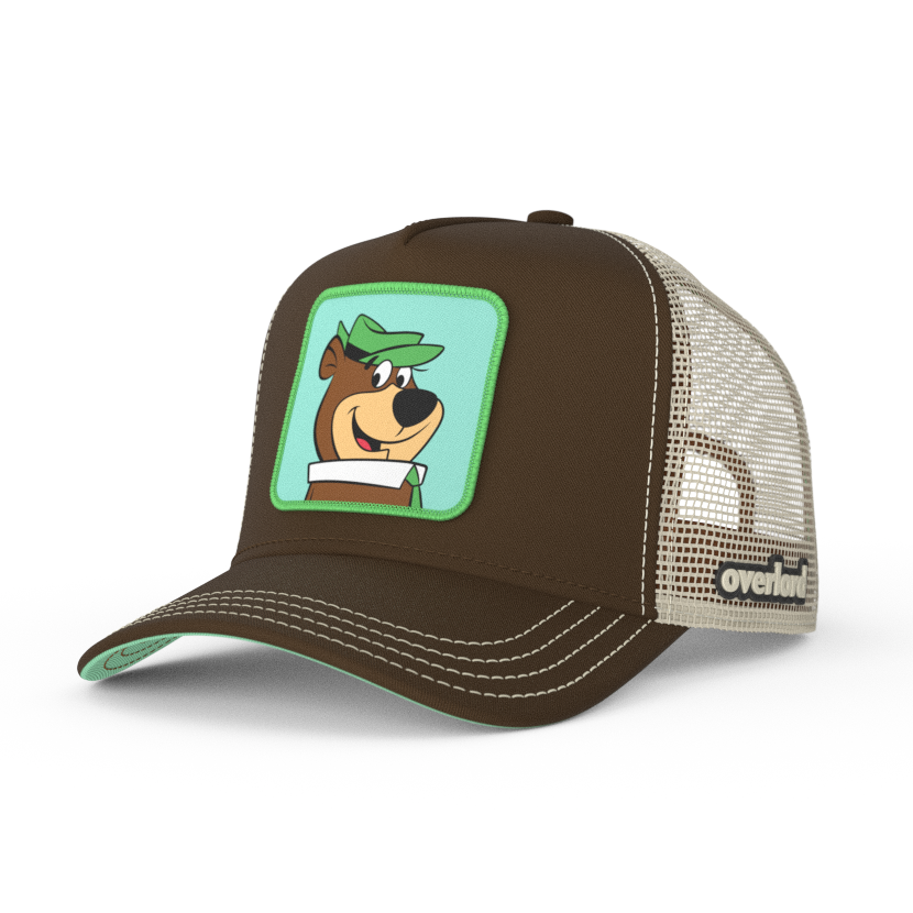 Brown twill trucker cap with khaki mesh featuring a woven patch of Yogi Bear attached to the crown.