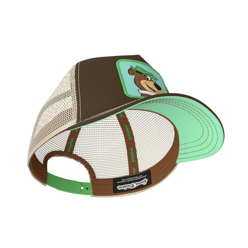 Brown twill trucker cap with khaki mesh featuring a woven patch of Yogi Bear attached to the crown.