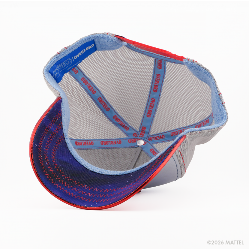 Underside of the He-Man from Masters of the Universe retro trucker cap, showing a purple starry-print brim, blue Masters of the Universe tag, grey mesh crown, and light blue Overlord branded taping with red text.