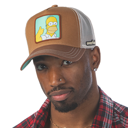 Man wearing brown OVERLORD X The Simpsons Homer doing thumbs up trucker baseball cap hat with khaki stitching. PVC Overlord logo.