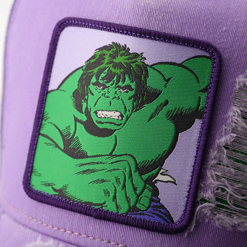 Close-up of a woven Marvel's Incredible Hulk patch with a purple border, stitched onto distressed purple cap fabric.