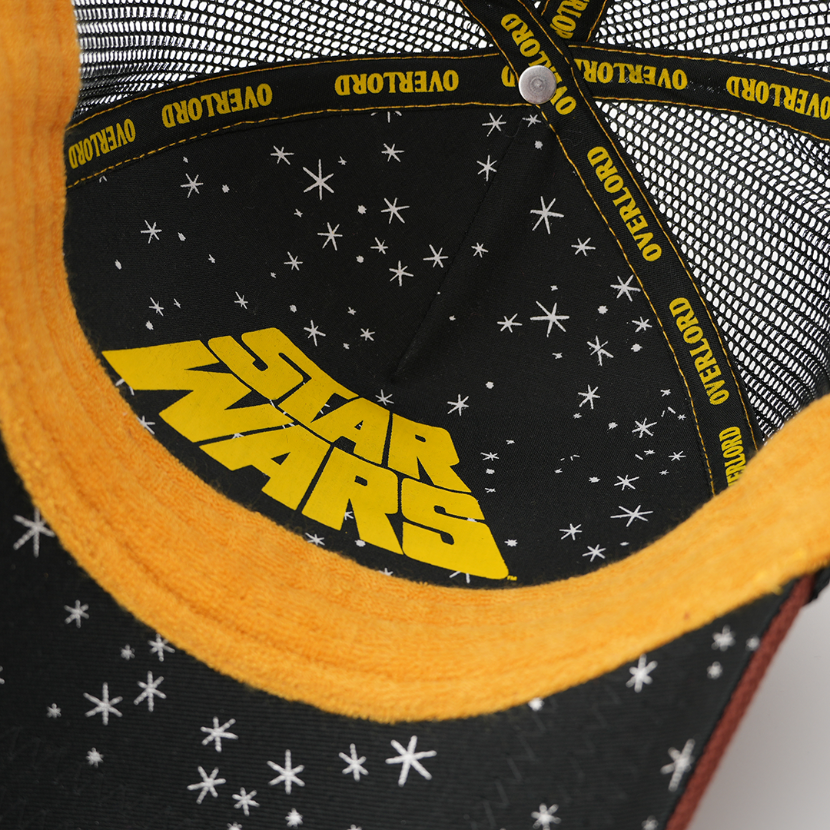 Close-up of the Jawa trucker cap's underside showing a starry black lining with a yellow Star Wars logo and Overlord taping.