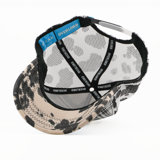 Cap with camouflage brim and patterned back on a white background