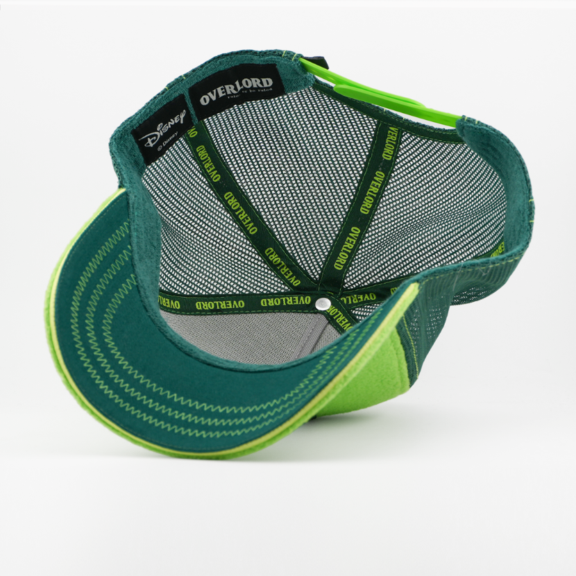 Underside of the Kermit the Frog retro trucker cap, showing a solid dark green brim, a Disney tag, gray mesh crown, and dark green Overlord branded taping with lime green text.