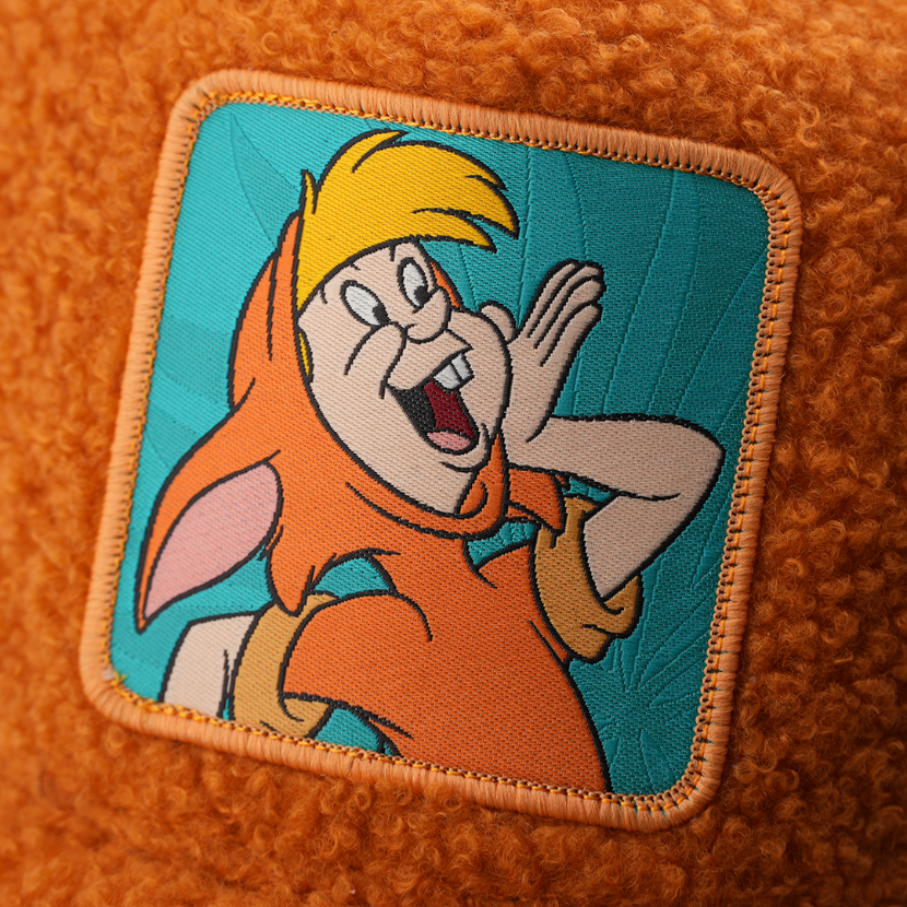 Close-up of a woven patch showing Lost Boy Slightly from Disney's Peter Pan shouting with a hand cupped to his mouth on a teal background, stitched onto fuzzy-textured burnt orange fabric with an orange border.