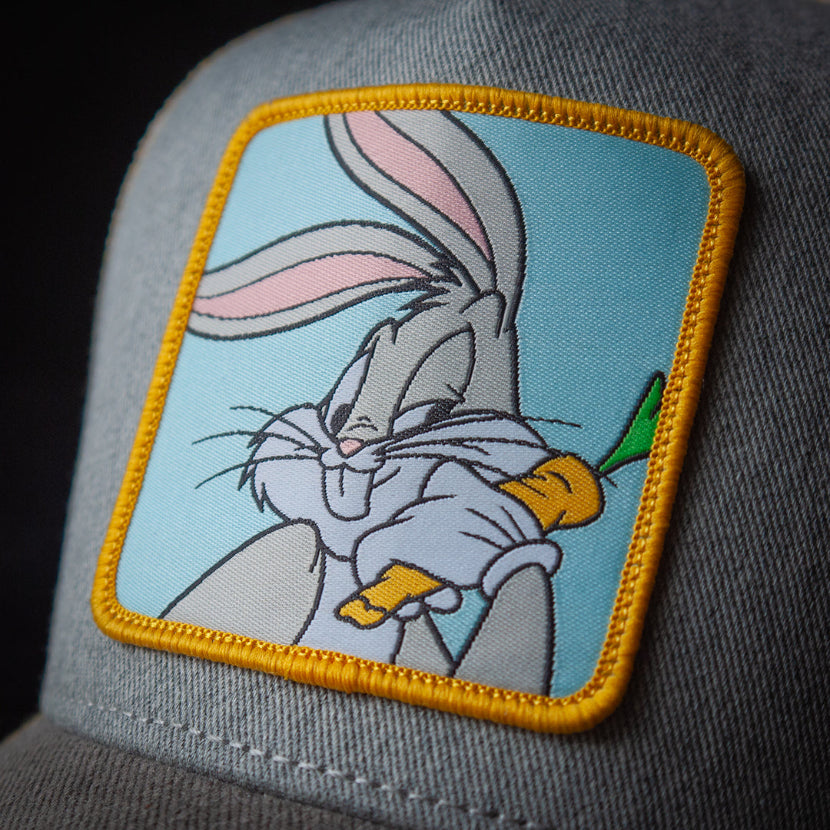 Patch of a cartoon rabbit holding a carrot on a gray cap