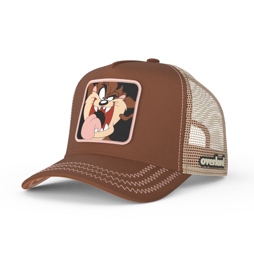 Brown OVERLORD X Looney Tunes smiling Tasmanian Devil trucker baseball cap hat with pink zig zag stitching. PVC Overlord logo.