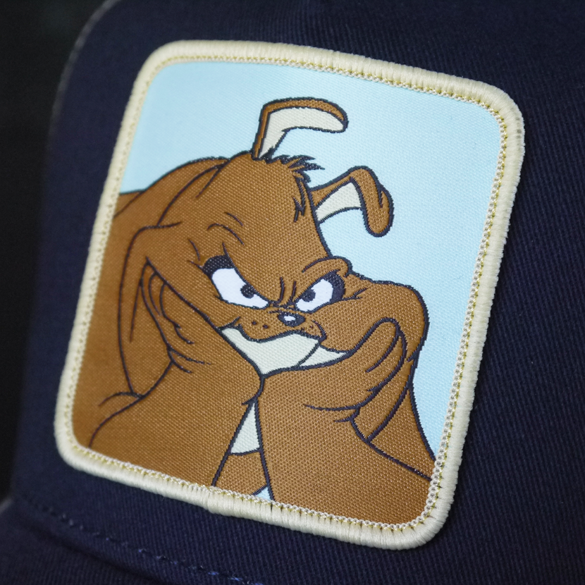 Navy Blue OVERLORD X Looney Tunes Marc Anthony the dog trucker baseball cap hat woven Overlord patch closeup.