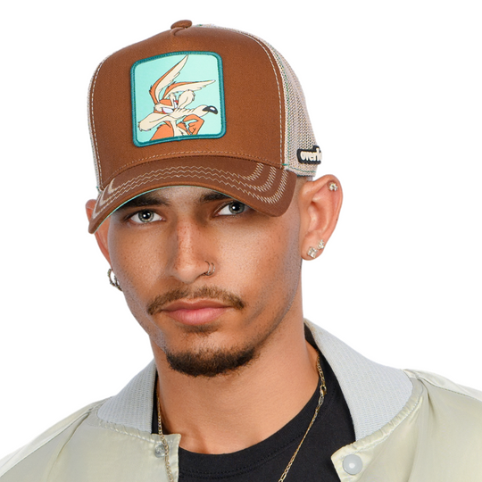 Man wearing brown OVERLORD X Looney Tunes thinking Wile E. Coyote trucker baseball cap hat with khaki zig zag stitching. PVC Overlord logo.