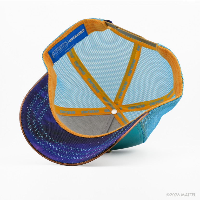 Underside of the Man-At-Arms from Masters of the Universe retro trucker cap, showing a purple starry-print brim, blue Masters of the Universe tag, light blue mesh crown, and gold Overlord branded taping.