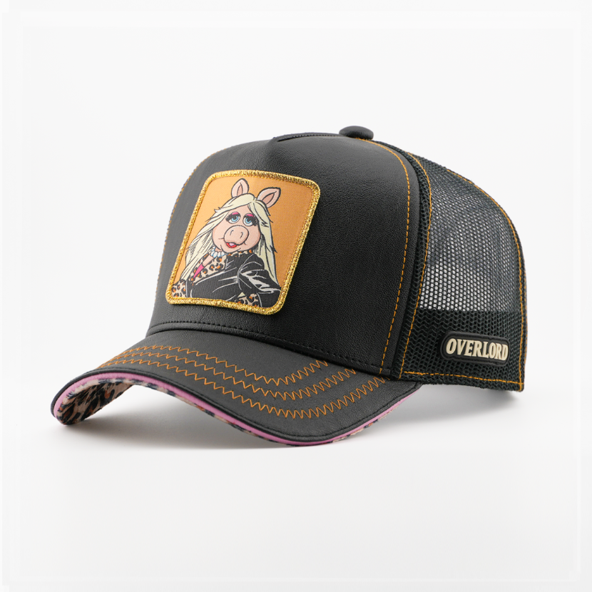 Black faux-leather retro trucker cap with a leopard-print brim underside and a patch of Miss Piggy from The Muppets in a leopard-print jacket on an orange background, black mesh back with tan Overlord logo.