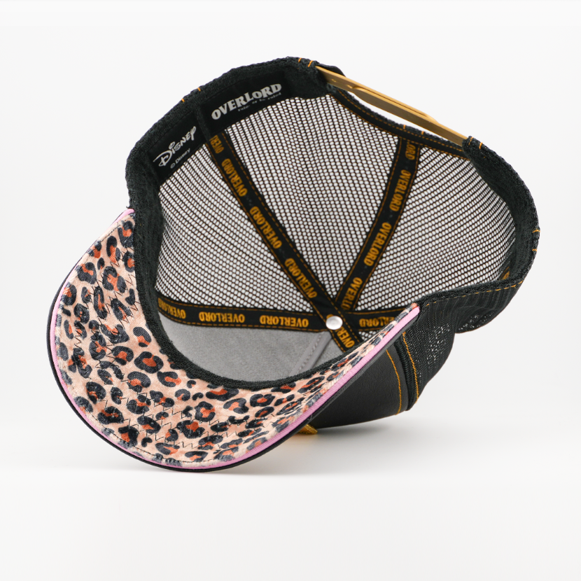 Underside of the Miss Piggy retro trucker cap, showing a leopard-print tan brim, a Disney tag, black mesh crown, and black Overlord branded taping with orange text.