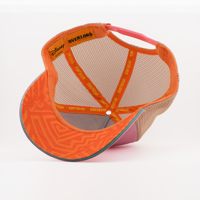 Underside of the young Nala from Disney's The Lion King retro trucker cap showing an orange patterned brim with teal trim, tan mesh crown, Disney tag, and orange Overlord branded taping with yellow text.