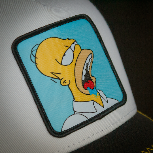 White and black OVERLORD X The Simpsons Homer drooling trucker baseball cap hat woven Overlord patch closeup.