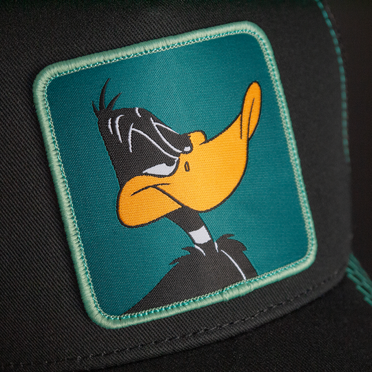 Black OVERLORD X Looney Tunes Daffy Duck trucker baseball cap hat woven Overlord patch closeup.