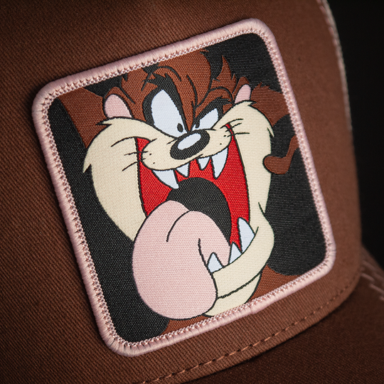 Brown OVERLORD X Looney Tunes smiling Tasmanian Devil trucker baseball cap hat woven Overlord patch closeup.