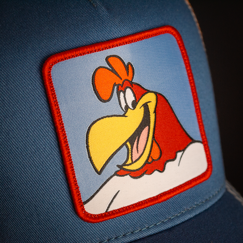 Blue OVERLORD X Looney Tunes smiling Foghorn trucker baseball cap hat woven Overlord patch closeup.