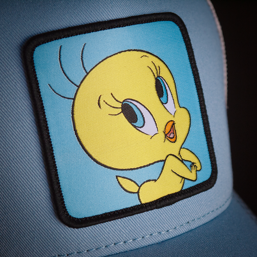 Baby Blue OVERLORD X Looney Tunes smiling Tweety Bird trucker baseball cap hat woven Overlord patch closeup.