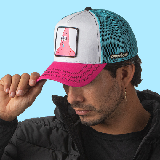 Man wearing white and pink OVERLORD X SpongeBob Drooling Patrick trucker baseball cap hat with black zig zag stitching. PVC Overlord logo.