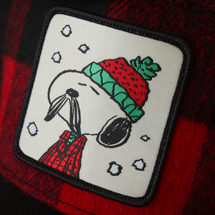 Close-up of a woven patch of Lumberjack Snoopy from the Peanuts attached to the crown.