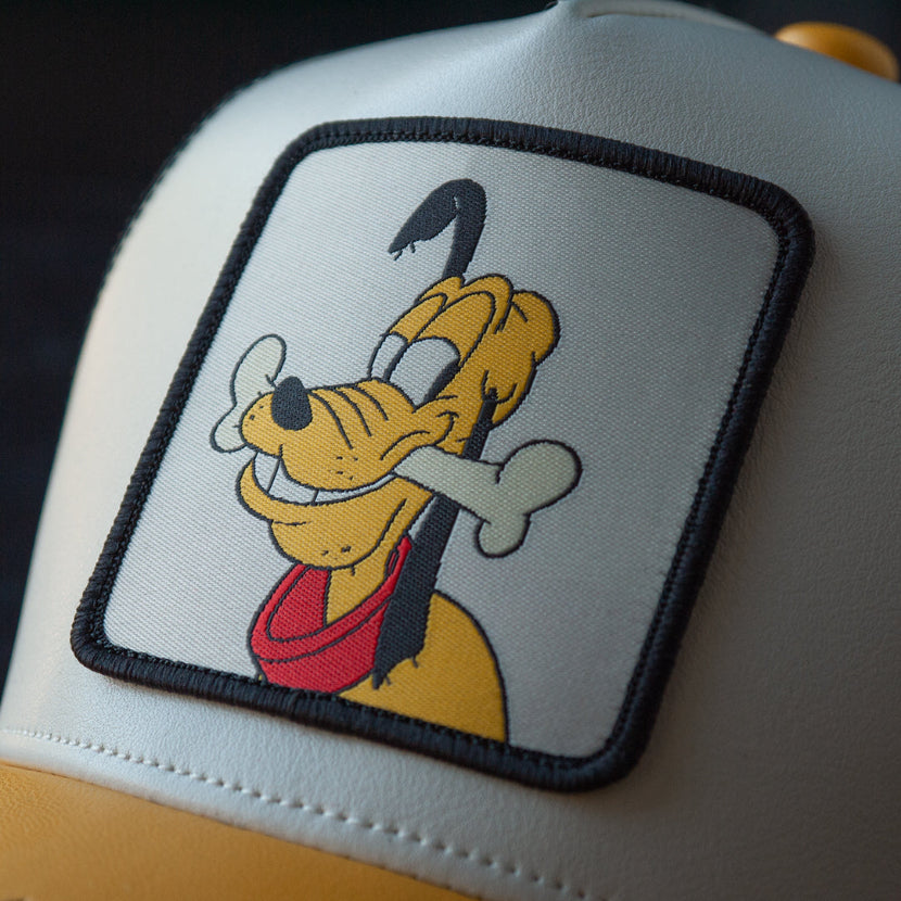 Trucker hat with a cartoon character patch on a dark background
