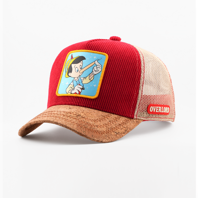 Red and brown cap with cartoon character patch on a white background