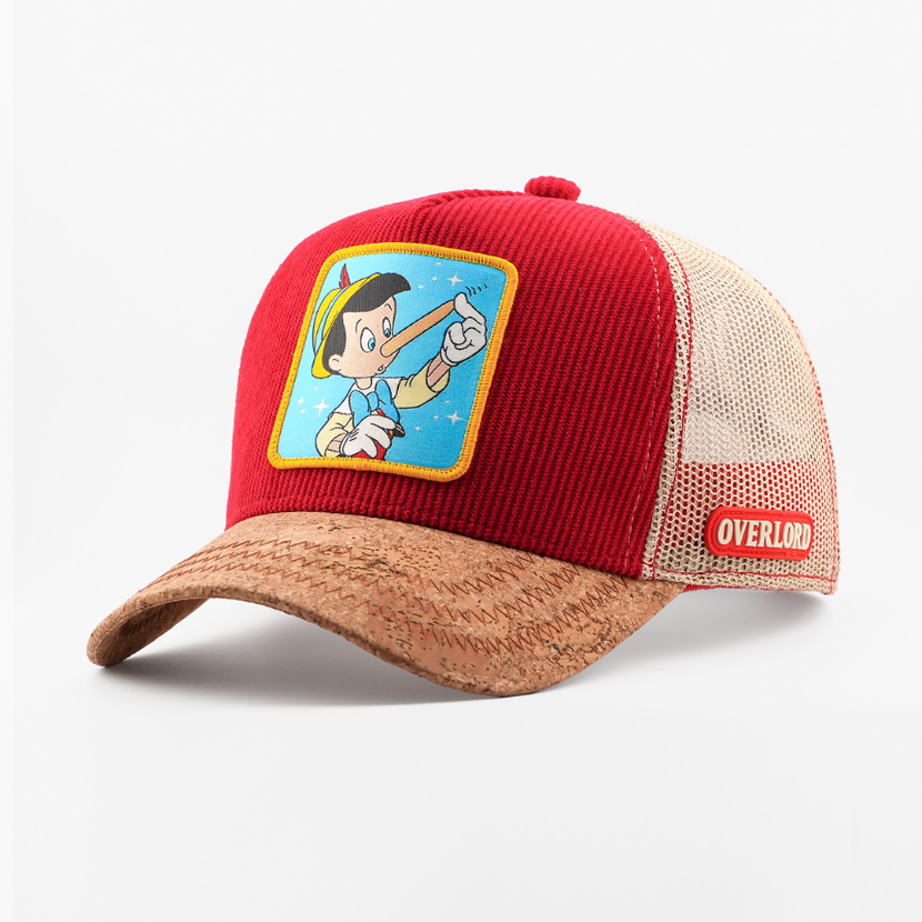 Red ribbed-texture Pinocchio from Disney's Pinocchio retro trucker cap with a cork-textured brim, tan mesh side, and Overlord logo.